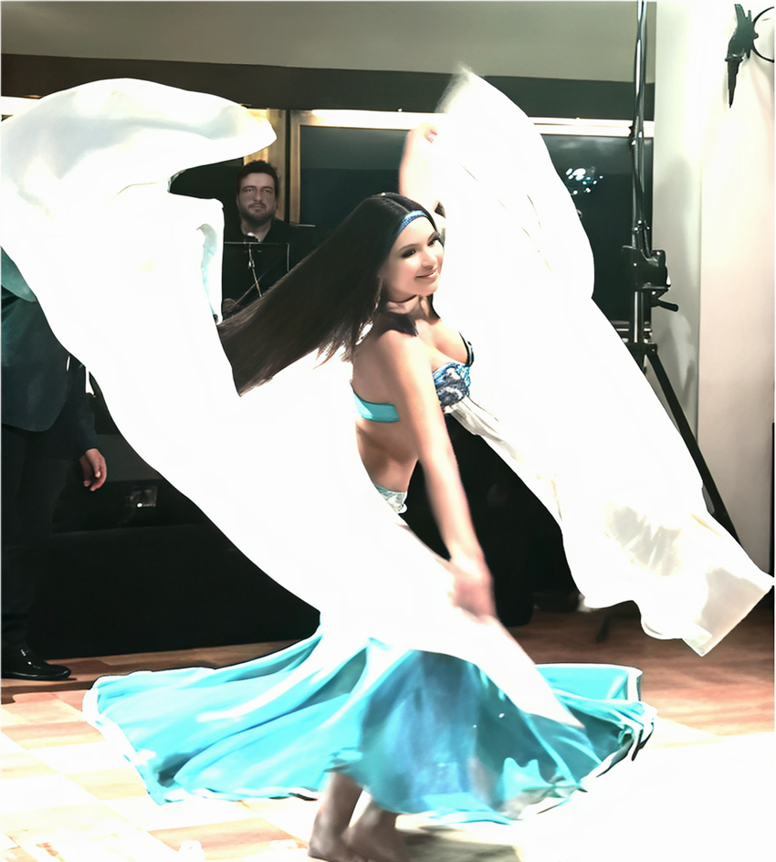 Coni spinning with a white veil and turquoise skirt